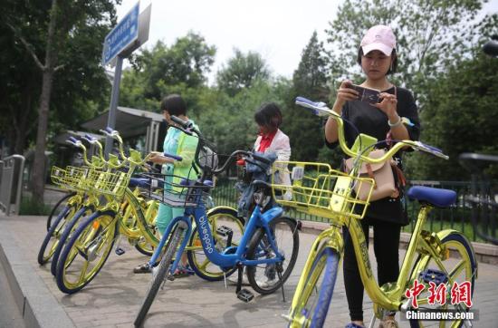 資料圖 6月8日，民眾在北京街頭掃碼租用一款“土豪金”色的共享單車。 <a target='_blank' href='http://www.chinanews.com/'>中新社</a>記者 楊可佳 攝